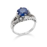 A sapphire and diamond ring The cushion-shaped sapphire, weighing approx. 2.88 carats, to a four-