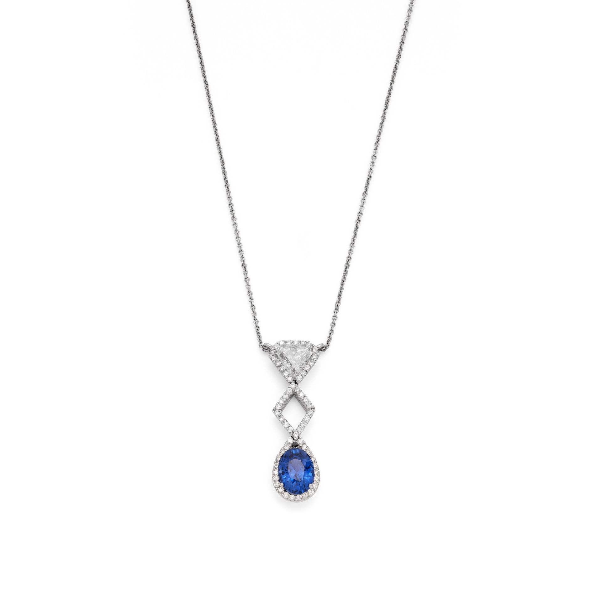 A sapphire and diamond pendant necklace The oval-cut sapphire, suspended from a triangular-cut