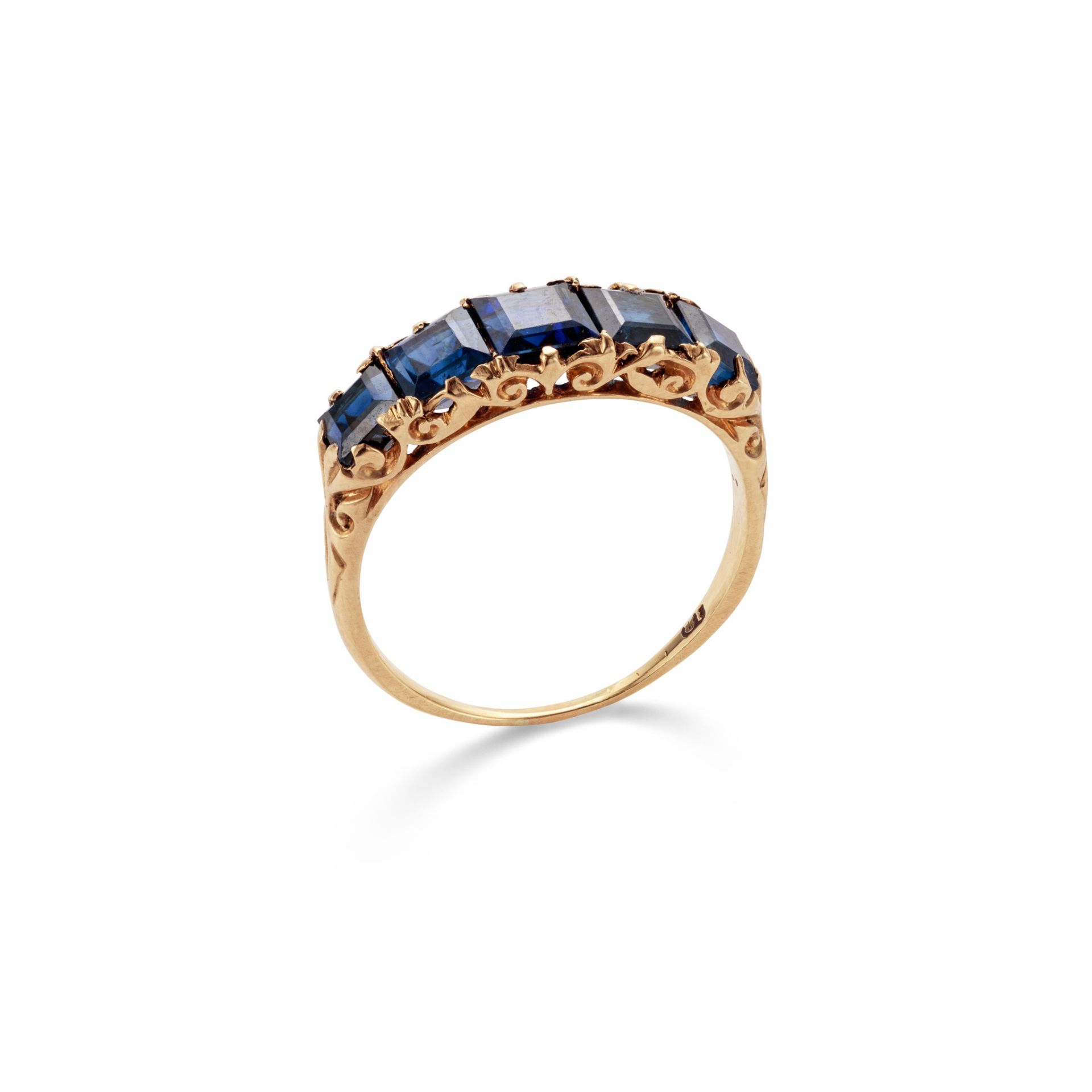 A sapphire five-stone ring Set with five graduated square-cut sapphires, to a scrolled gallery and