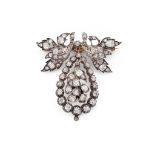 A late 19th century diamond brooch Designed as a foliate surmount, suspending a pear-shaped drop