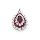 A ruby and diamond pendant / brooch The pear-shaped ruby, within a tiered pear-shaped surround,