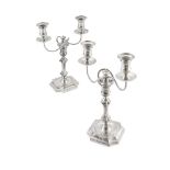 A matched pair of Victorian George II style silver two branch table candelabra