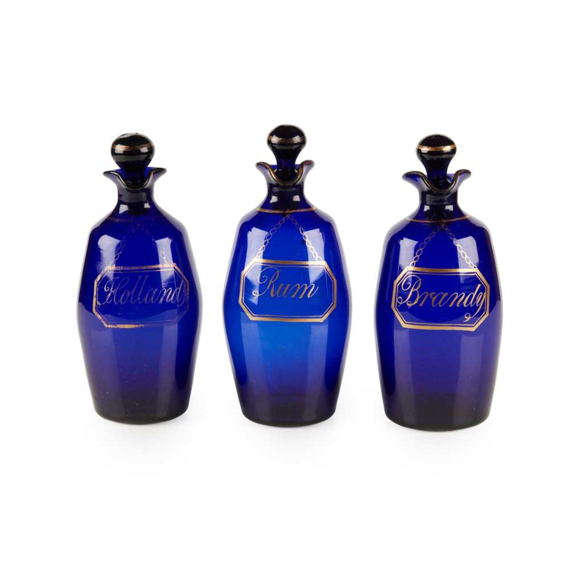 A SET OF THREE BRISTOL BLUE GLASS DECANTERS AND STOPPERS EARLY 19TH CENTURY