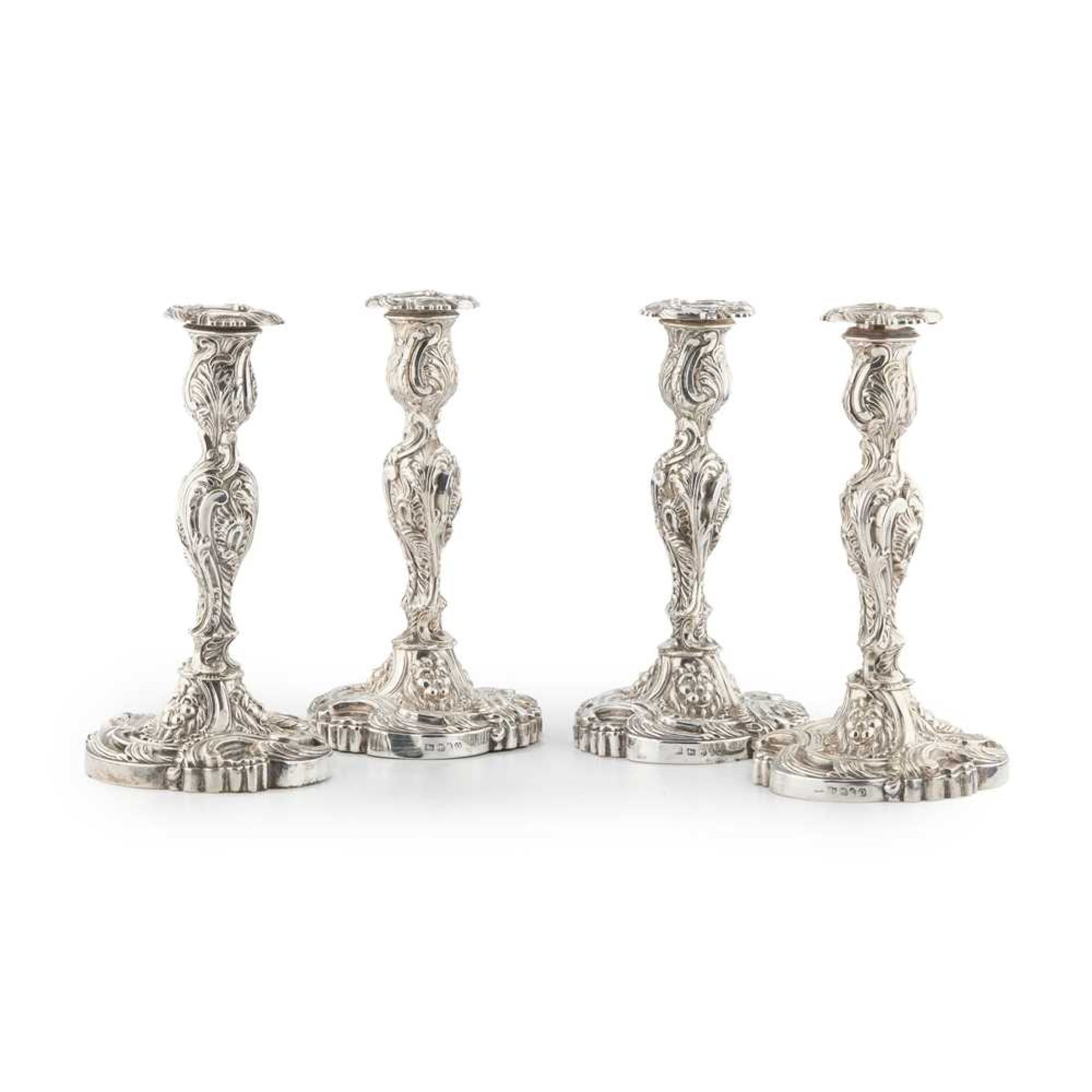 A SUITE OF FOUR GEORGE III TABLE CANDLESTICKS AND A PAIR OF THREE LIGHT CANDELABRA S C YONGE & CO, S