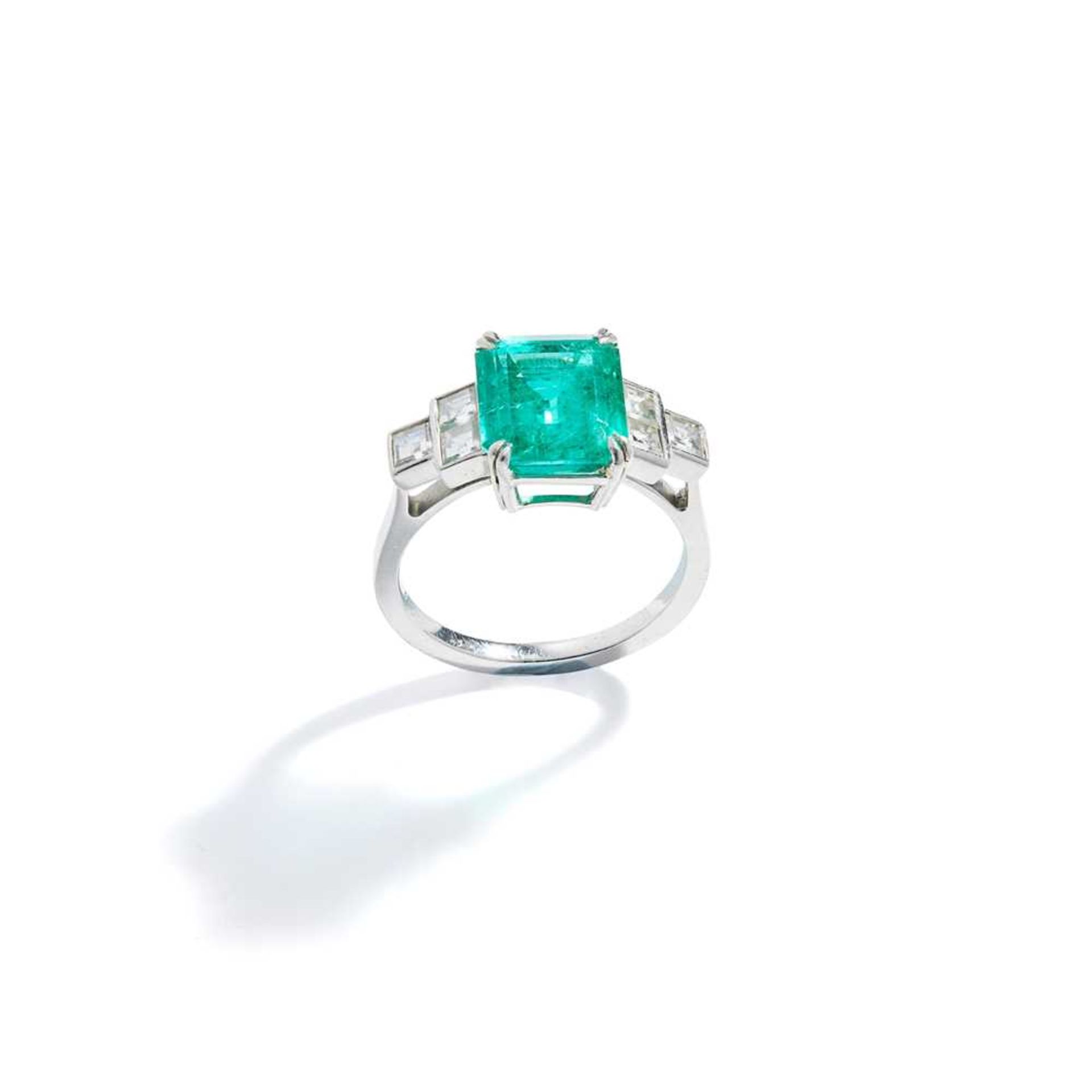 An emerald and diamond ring