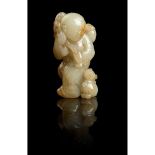 WHITE JADE WITH RUSSET SKIN CARVING OF A BOY WITH CAT QING DYNASTY, 18TH CENTURY