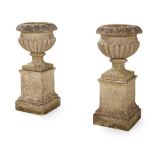 PAIR OF COMPOSITION STONE URNS AND PEDESTALS 20TH CENTURY
