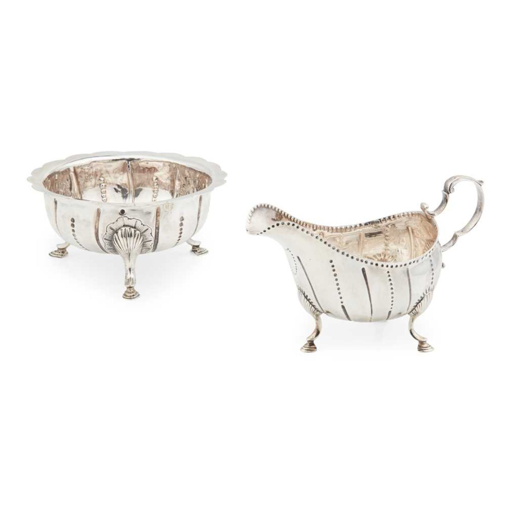 A George III Irish three footed sugar basin and matched cream boat