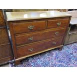 An Edwardian walnut chest of drawers, with two short and two long graduated drawers on bracket feet,