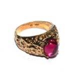 A gentlemans 9 carat gold ring set with cabochon red stone