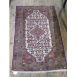 A Hamadan rug, the central medallion in an ivory serrated field filled with stylised flowers