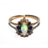 A 9 carat gold ring set with opal, sapphire and diamond