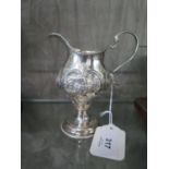 A George III silver cream jug, decorated in relief on single foot, inscribed 'Mary Watson 1794'
