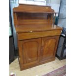 A mid Victorian mahogany chiffonier, the raised back with shelf over a long drawer and a pair of