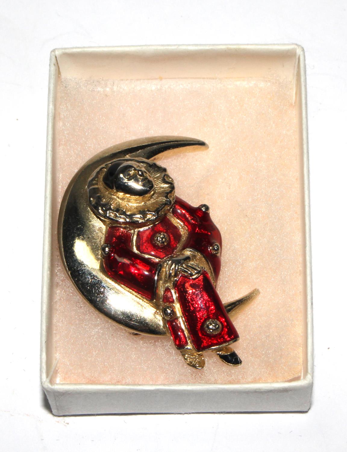 A Butler & Wilson enamelled brooch, in the form of a Pierrot sitting in crescent moon, in box