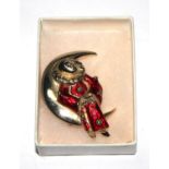 A Butler & Wilson enamelled brooch, in the form of a Pierrot sitting in crescent moon, in box