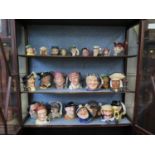 A collection of Royal Doulton character jugs, including Bacchus and Veteran Motorist, eight