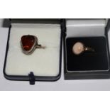 Two silver rings in boxes, one mounted amber, the other gold plated with full hallmark and set