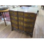 A reproduction mahogany chest of drawers, with ebony stringing, the shaped front with four graduated