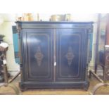 A late Victorian parcel gilt ebonised side cabinet, the twin doors enclosing a velvet lined