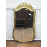 A George I style giltwood wall mirror, the shaped frame with flowerhead and foliate scroll surmount,