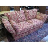 A Knole style settee, with red foliate design upholstery, 223 cm wide