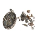 A silver locket and chain and a collection of earrings