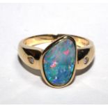 A 14 carat gold ring set with two small diamonds and and opal doubles