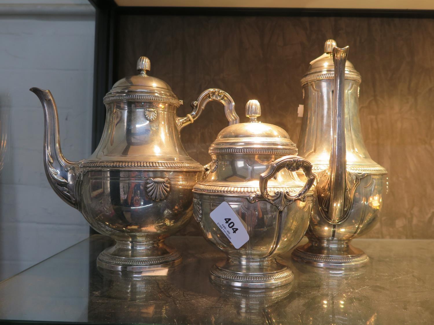 A Continental silver coloured metal tea set consisting of a coffee pot, tea pot and a lidded sugar