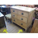 A late Victorian pine chest of drawers, with two short and two long graduated drawers on turned
