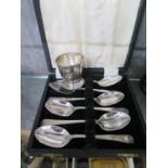 A set of six cased tea spoons and a silver egg cup