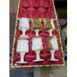 A set of six onyx goblets, 12.5 cm high, cased, one chipped, a pair of gilt metal wall lights, a
