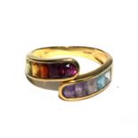 An 18 carat gold ring set with ten assorted stones