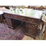 A reproduction mahogany pedestal desk, the leather inset top over three frieze drawers above three