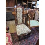 A Victorian walnut nursing chair, the scrolling turned back with upholstered panel, on cabriole legs