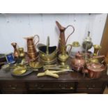 Various copper and brass wares, including coal helmet, kettles, jugs, oil lamps and shoe horns