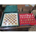 An onyx chess set, in green and brown, in a felt case, board 40.5 cm square, some damage to the