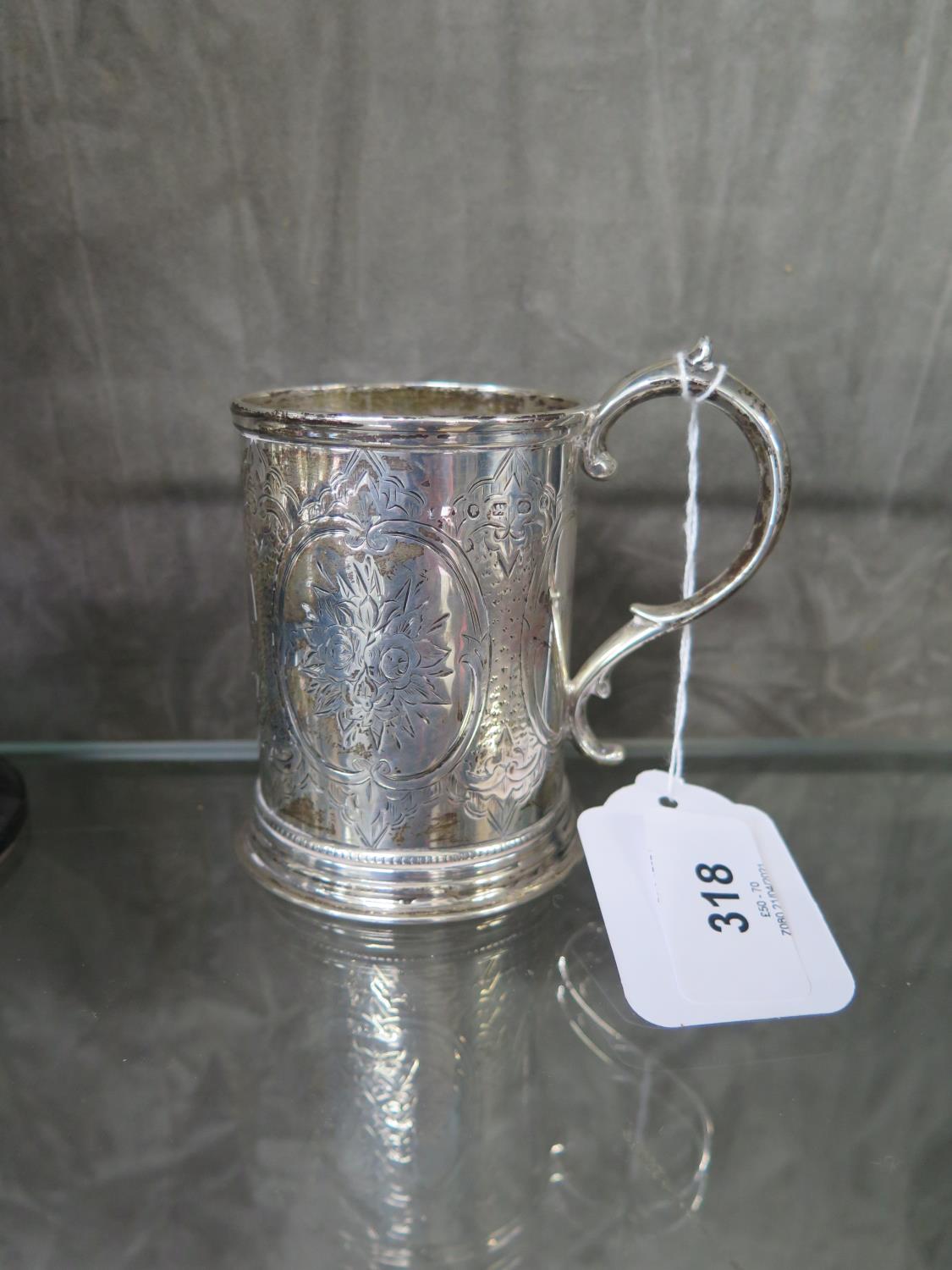 A Victorian silver mug decorated in relief and monogrammed