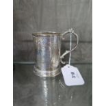 A Victorian silver mug decorated in relief and monogrammed