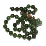 Two pairs of jade earrings and a jade necklace