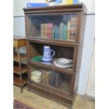 A Globe Wernicke type oak stacking bookcase, with three glazed fall front compartments (one