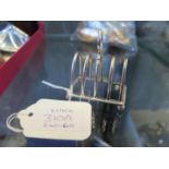 A miniature silver toast rack of four divisions, 5.2 cm