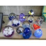 Two Caithness paperweights, a Selkirk glass paperweight and nine other similar paperweights (12)