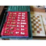 An onyx chess set, in green and brown, in a felt case, board 40.5 cm square, some damage to the