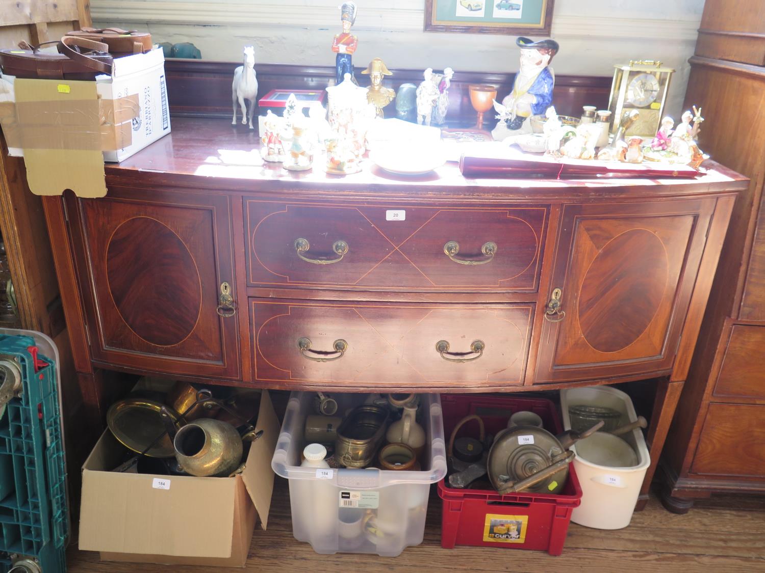 A mahogany bowfront sideboard, with two central drawers flanked by cupboard doors on square legs and