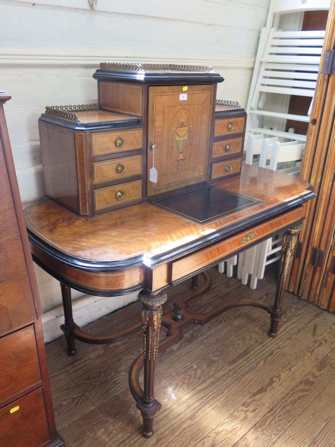 A late Victorian French style satinwood and inlaid writing desk, the top with central urn inlaid