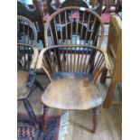 A yew and elm spindle back Windsor chair, with moulded seat and turned legs joined by turned