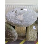A staddle stone, the top fixed to the base, 52 cm diameter, 76 cm high