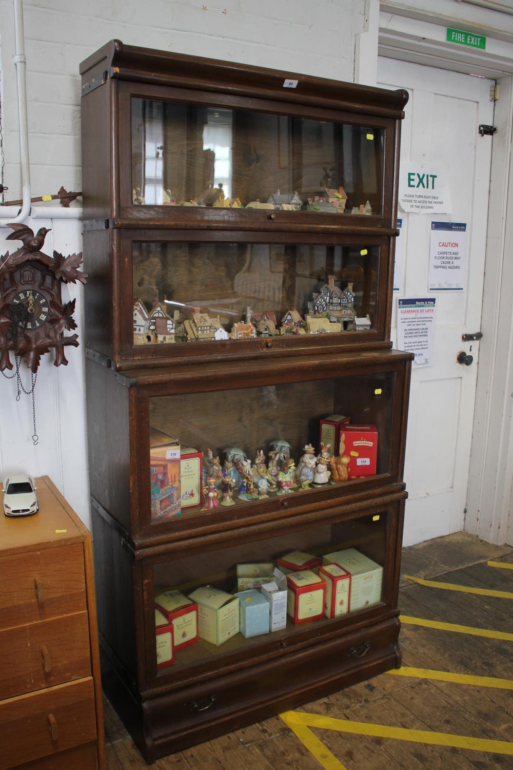 A Globe-Wernicke type stacking bookcase, the four graduated and stepped shelves with glazed fall