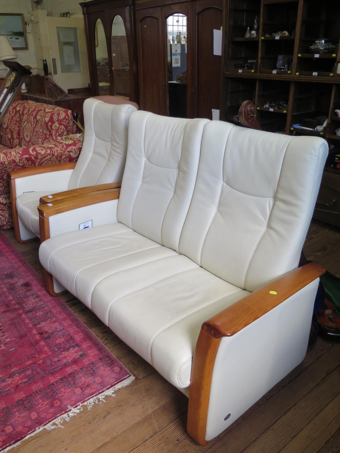 A Himolla cream leather two seat settee and matching armchair, settee 148 cm wide